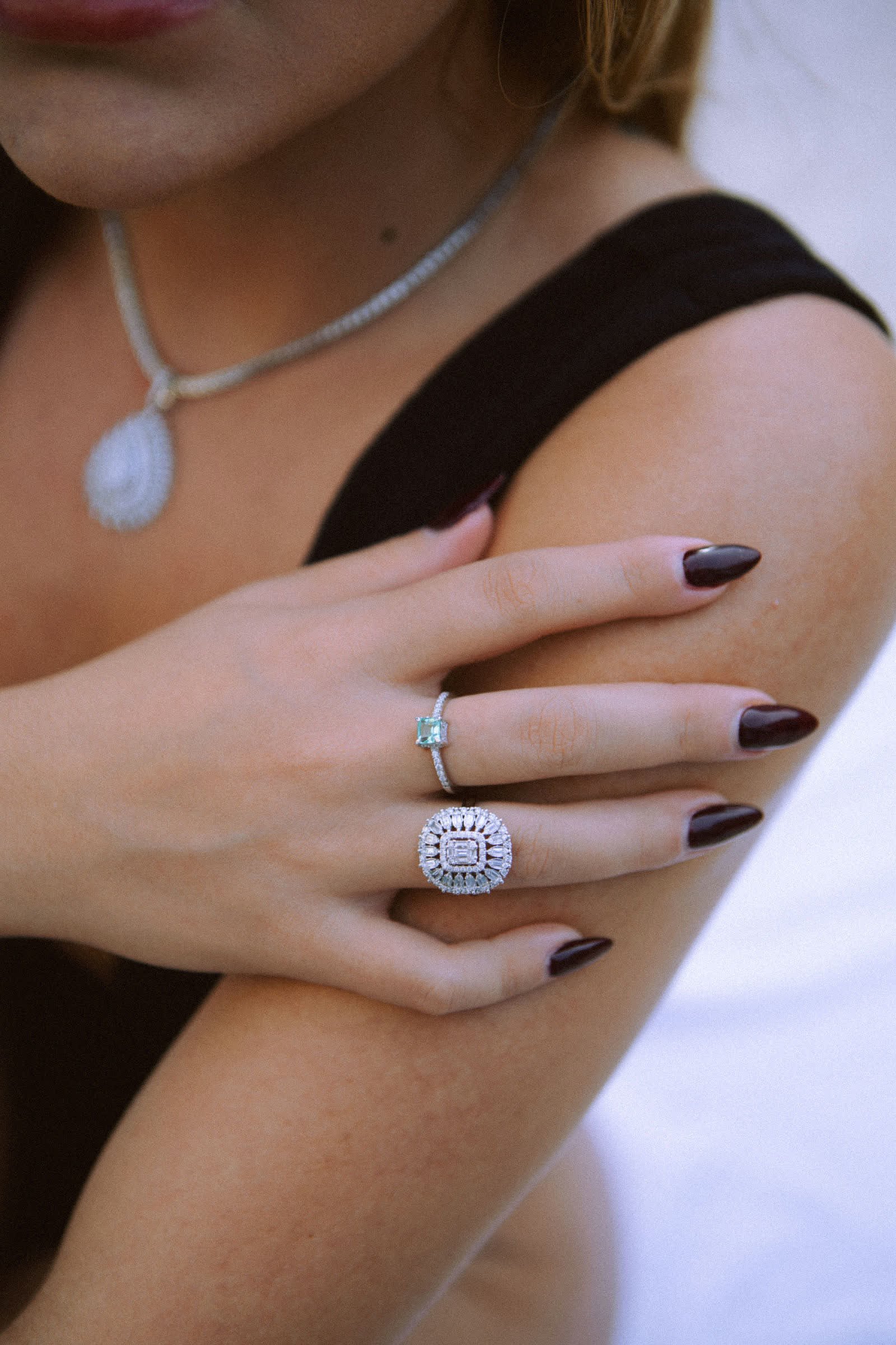 Imperial Ring — A baguette center under a double halo, cushion-shaped.